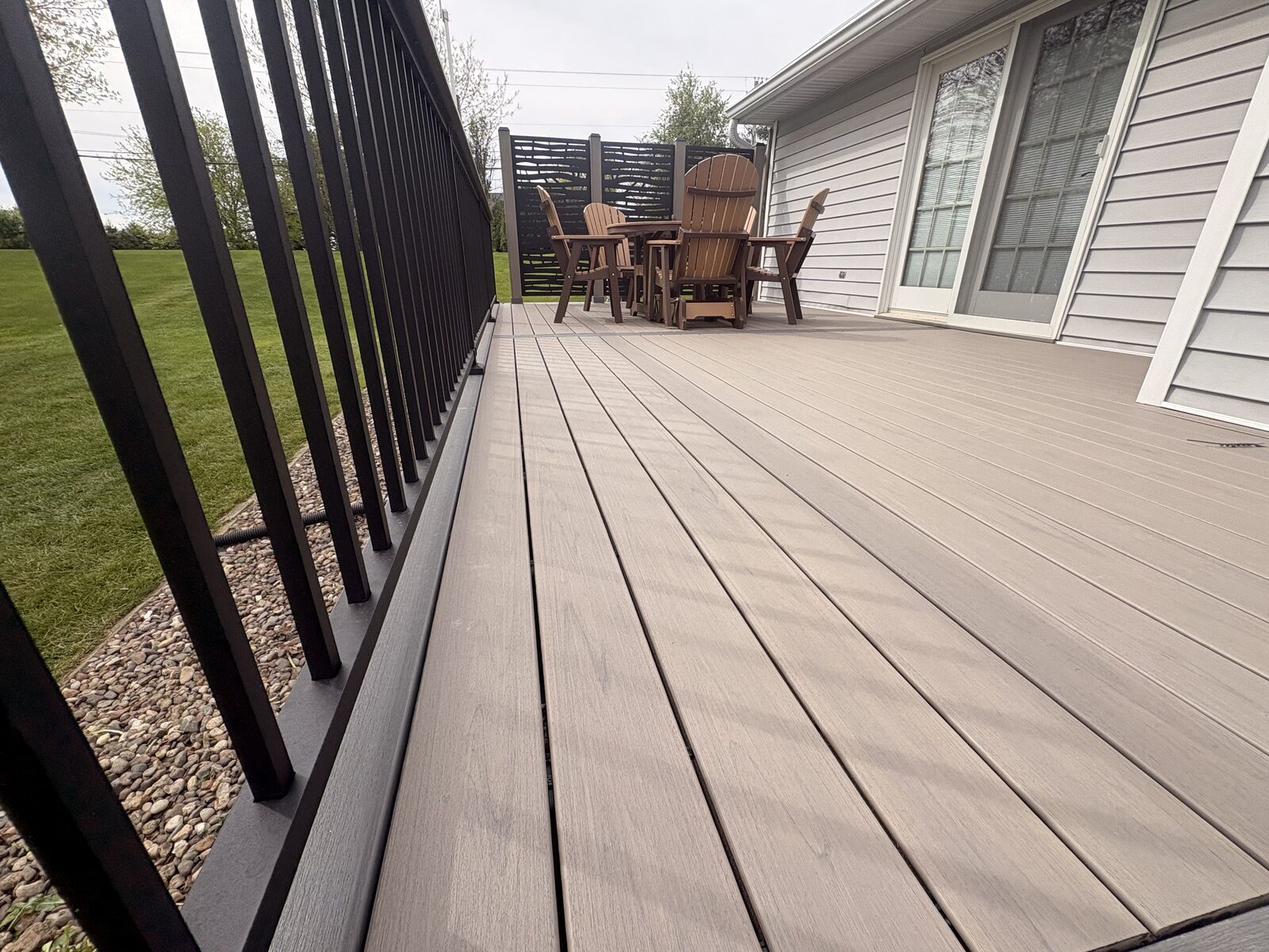 Composite deck surface with Adirondack chairs and privacy screen, Iowa City IA