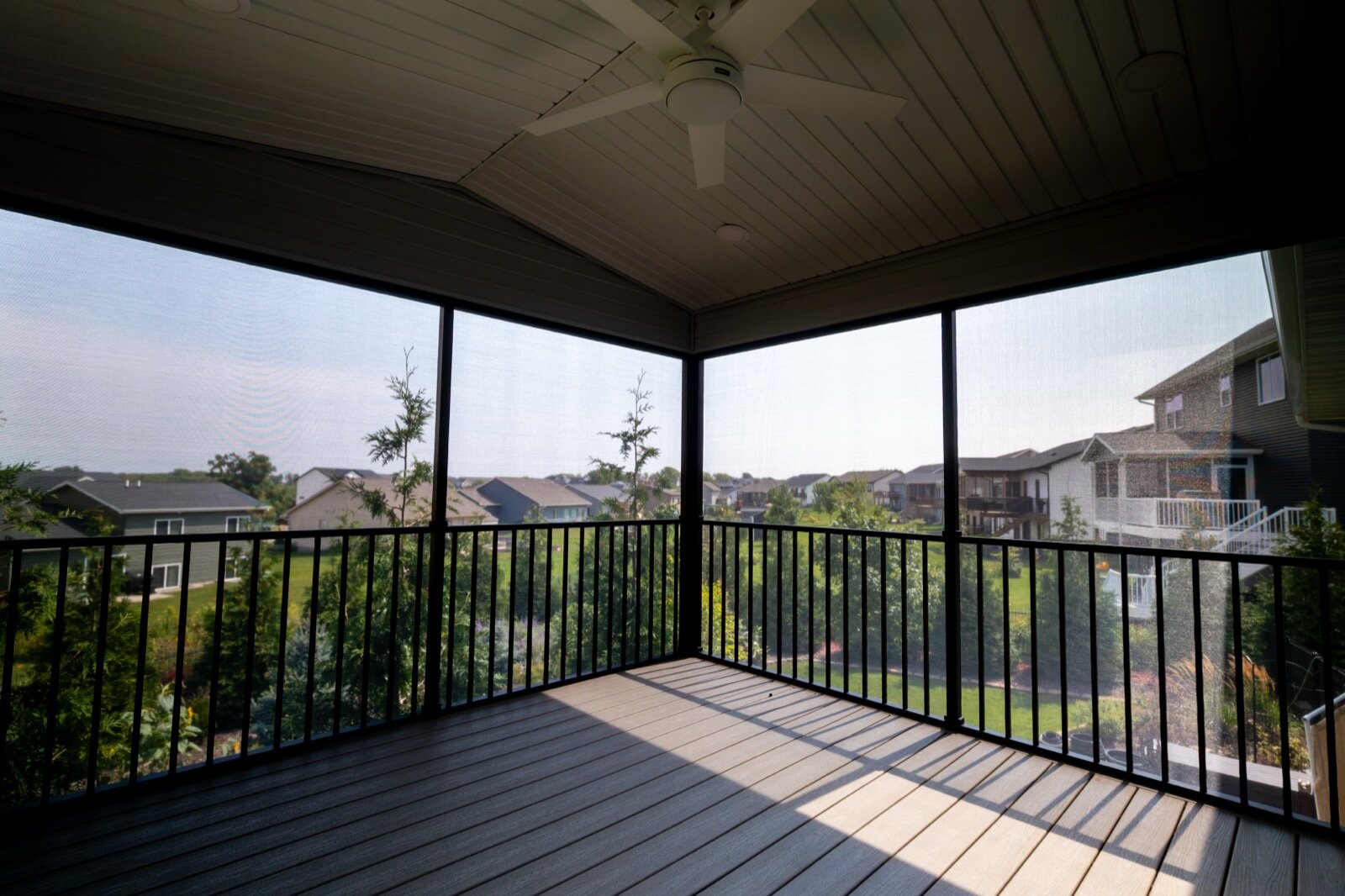 Custom-framed screen room with ceiling fan and composite decking